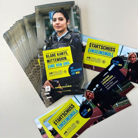 Ein Stapel Flyer der Polizei Baden-Württemberg wirbt für Karrieremöglichkeiten mit dem Slogan "Klare Kante. Mittendrin."